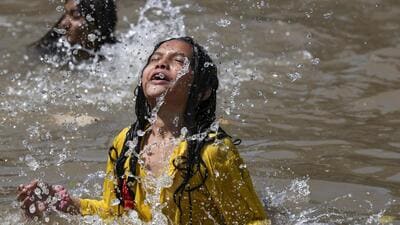 A child beats the heat on a hot summer day in Jamm 1777460685875