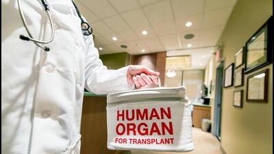 A doctor taking or delivering a bag containing a h 1777228650605