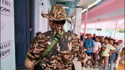 Voters stand in a queue at a polling station to ca 1777034245204
