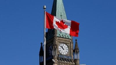 A Canadian flag flies in front of the Peace Tower 1777959089332