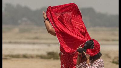 A woman covers herself and a kid on a hot summer d 1779208675016