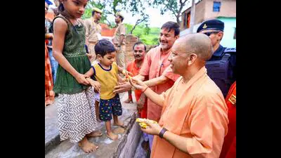 Chief minister Yogi Adityanath offers a chocolate 1783605821818